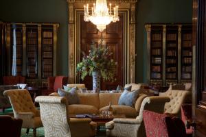 a living room with a couch and chairs and a chandelier at Wynyard Hall Hotel & Spa in Billingham