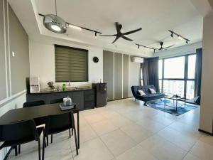 a kitchen and living room with a table and a ceiling fan at Industrial Style 2 Bedroom Unit Urban Suites Georgetown Sea View Jelutong in Jelutong