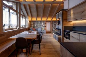 a kitchen with a table and chairs in a room at Chalet Matilde in Padola