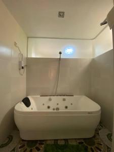 a white bath tub in a bathroom with a phone at BELLADAMA HOTEL in San Carlos