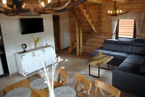 a living room with a couch and a table at Chaty NOVA pri Pieninách in Spišská Stará Ves