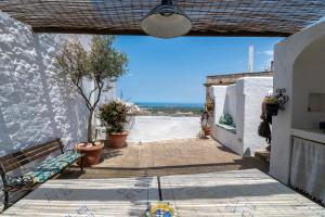 Ein Gehweg mit einer Bank und Blick auf das Meer in der Unterkunft Borgo&Mare in Ostuni