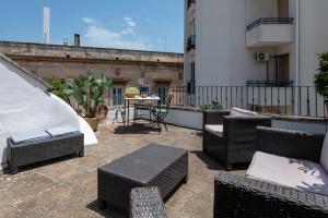 a patio with wicker chairs and a table on a building at Borgo&Mare in Ostuni