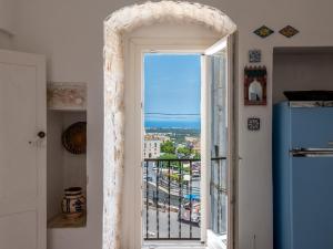 an open door to a balcony with a view of the ocean at Borgo&Mare in Ostuni