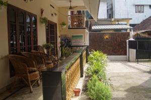 a restaurant with a counter with chairs and plants at Prems Homestay in Cochin