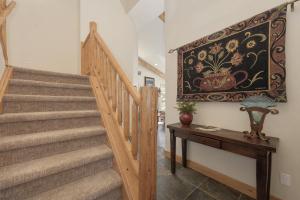 a staircase in a house with a painting on the wall at 103 Antler Way at Lakota townhouse in Winter Park
