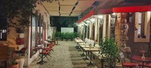 a hallway with tables and chairs in a restaurant at al'çatı flaneur in Çeşme