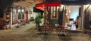 a row of stools in front of a restaurant at al'çatı flaneur in Çeşme