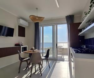 a kitchen and dining room with a table and chairs at Residence Panorama Palinuro in Palinuro