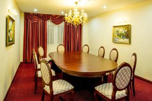 a dining room with a wooden table and chairs at Sai Gon Rach Gia Hotel in Rạch Giá