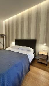 a bedroom with a large bed and a table at La Pennichella Vista Veneto in Agropoli