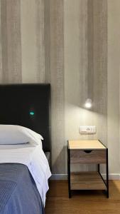 a bedroom with a bed and a nightstand next to a table at La Pennichella Vista Veneto in Agropoli