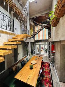 a large wooden table in a room with a couch at Art House Sweet home in Shymkent