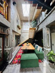 a living room with a table and green seats at Art House Sweet home in Shymkent