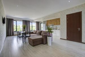 a large living room with a couch and a table at NOVEL hotel and Apartments in Korumdy
