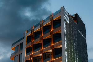 an office building with a sign on the side of it at Cozy Loft Hotel in Batumi