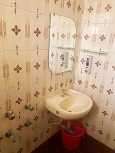 a bathroom with a sink and a mirror at Hotel Baga Sea Blue in Baga +19 photos
