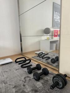 a room with weights on the floor in front of a mirror at Student Homestay in Im Teller +7 photos