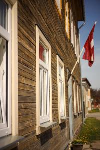a flag on the side of a building with a house at Ozolu apartment in Liepāja