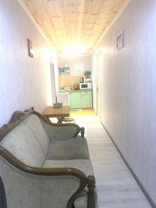 a living room with a couch and a table at guesthouse NENO in Mestia +51 photos