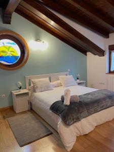 a bedroom with a large bed with a large window at Villa San Miguel in Cudón