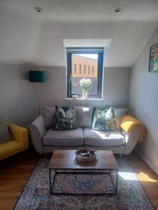 a living room with a couch and a coffee table at Ivy House Apartment in Ennis town with private access in Ennis