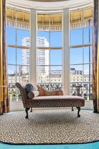 a living room with a couch in front of a large window at Hotel Pelirocco in Brighton & Hove