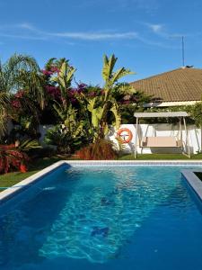 a blue swimming pool in front of a house at Villa Cambrils Mar in Cambrils
