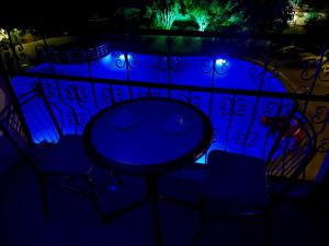 a table and chairs on a balcony at night at Angels Garden Dalyan in Dalyan +19 photos