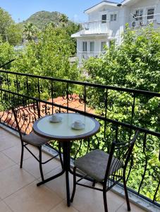 a table and two chairs sitting on a balcony at Angels Garden Dalyan in Dalyan