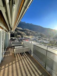 a balcony with two benches and a view of a city at Residenza Noemi in Bellinzona