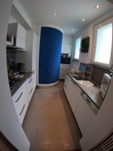 a kitchen with a sink and a blue wall at Casa Marchese in Tirrenia