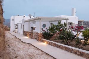a row of white buildings with lights on them at Halcyon Suites and Villas Naxos in Naxos Chora