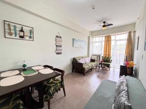 a living room with a table and a couch at Condo de Avila in Boracay