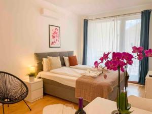 a bedroom with a bed and a vase with flowers at Opera Residence in Budapest