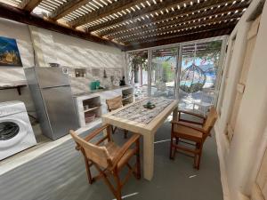 a kitchen with a table and chairs and a stove at Venereum Apartments in Faros