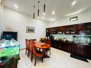 a dining room with a table and a fish tank at Bibi’s home in Danang