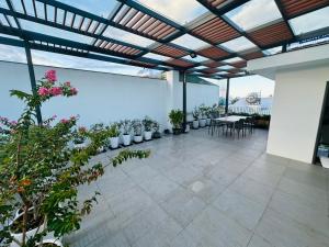 an indoor patio with potted plants and a table and chairs at Bibi’s home in Danang