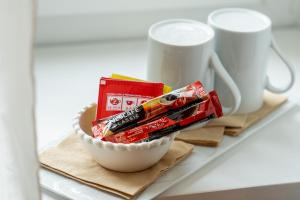 a bowl of candy on a counter next to two cups at I Remi Del Prione by Le 5 Terre La Spezia in La Spezia