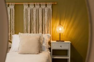 a bed with a white pillow and a lamp on a night stand at I Remi Del Prione by Le 5 Terre La Spezia in La Spezia