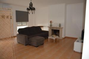 a living room with a couch and a fireplace at Albergue Santa Justa in Moura