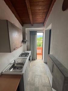 a kitchen with a sink and a stove at Casa Giuli in Villasimius +8 photos