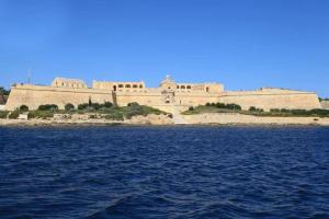 a large building on an island in the water at NR Retreat in Il-Gżira