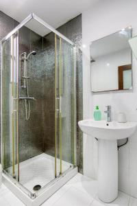 a bathroom with a shower and a sink at NR Retreat in Il-Gżira