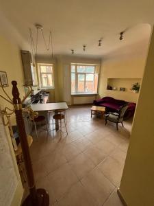 a kitchen and living room with a table and chairs at BestHomeRiga in Rīga
