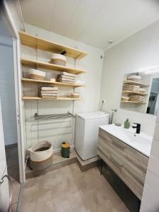 a bathroom with a sink and a toilet in it at La Maison Cosy in Frontenay +14 photos
