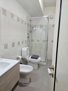 a bathroom with a shower and a toilet and a sink at Hotel Fernanda in Letojanni