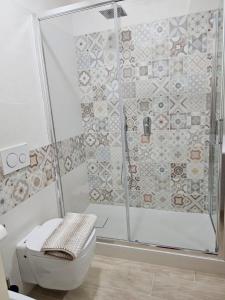 a bathroom with a shower and a toilet at Hotel Fernanda in Letojanni