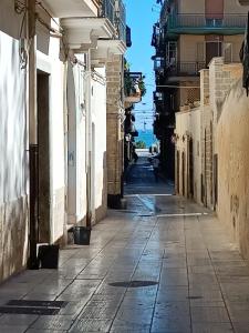an empty street in a city with the ocean at Pascasio17 in Mola di Bari