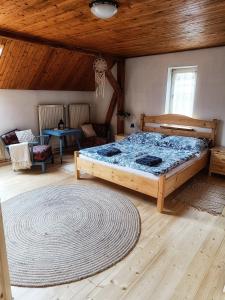 a bedroom with a bed and a wooden ceiling at Tuhaň dům na samotě u lesa in Tuhaň